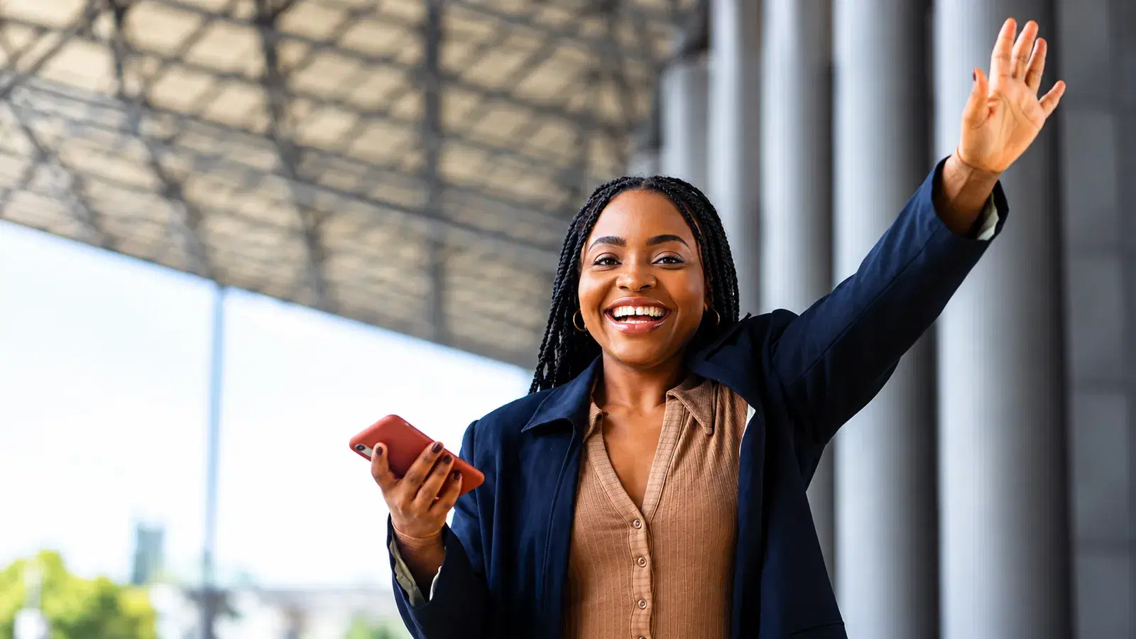 Joyful woman holding her phone after an instant money transfer